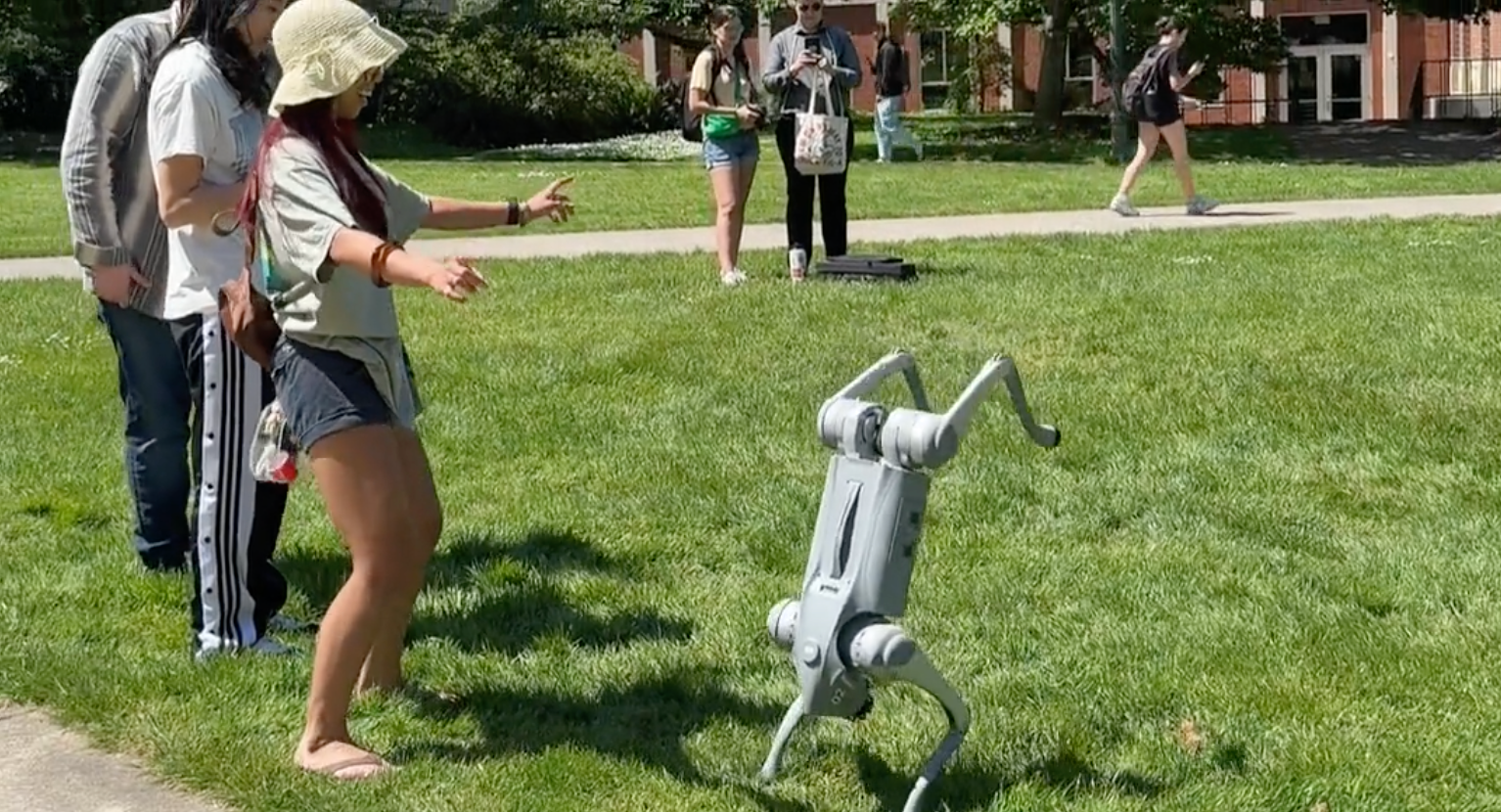 Studennts interacting with an AI robotic dog